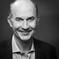 A headshot of Carter Roberts smiling at the camera