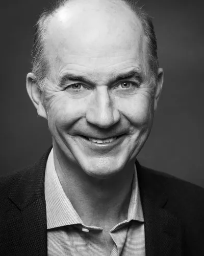 A headshot of Carter Roberts smiling at the camera