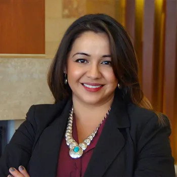 A color photo of woman in professional attire