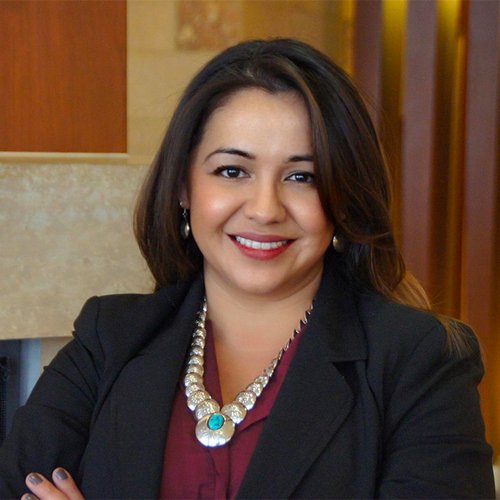 A color photo of woman in professional attire