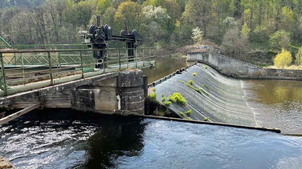 A large dam in a stream spillway in the mountains.