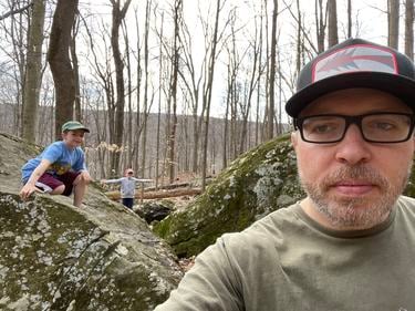 Dan Buchner and his two children in a forest