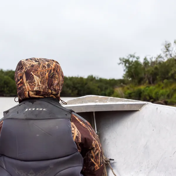 Dana Okitun, son of Marvin Okitun, looks ahead from bow of boat on Yukon River