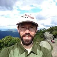 Headshot of David Flickinger with mountains in background