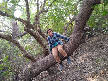 WWF Scientist Dina Rasquinha sits on a tree branch