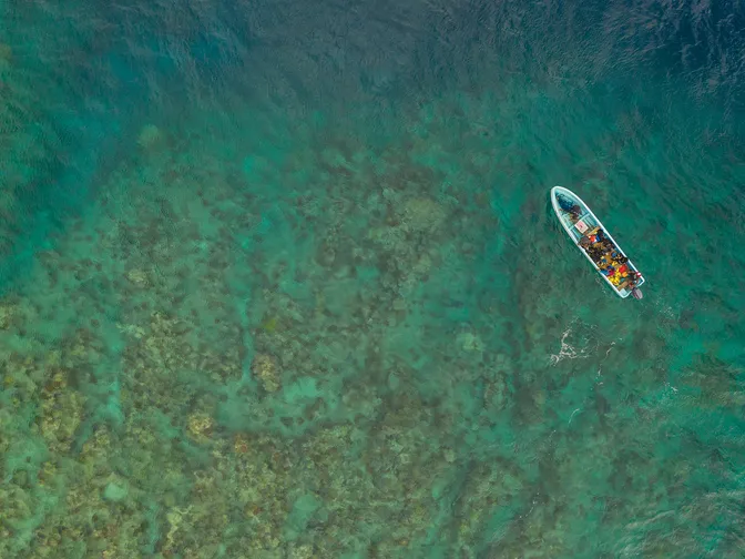 A diving skiff about to anchor at a reef north of Vanua Levu, Fiji