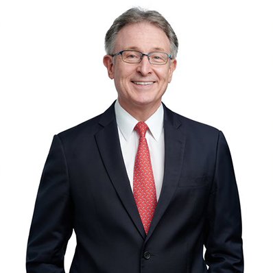 A headshot of a man smiling at the camera