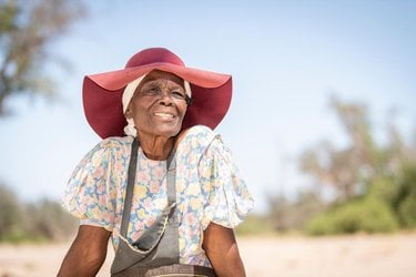 Rebecca Adams sits outside De Riet village, Namibia