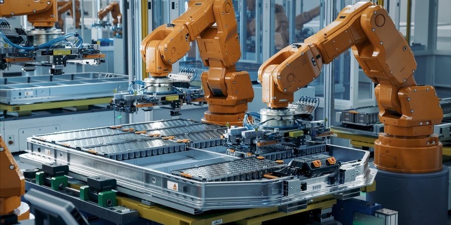 Orange robot arms assembling equipment