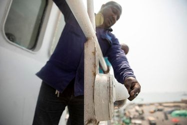 Richard Ahene Niunoo (Second Officer) inspects a Satlink camera, an on-ship camera system on a boat.