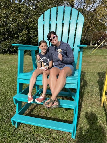 Skye and Erin sit together in a giant chair