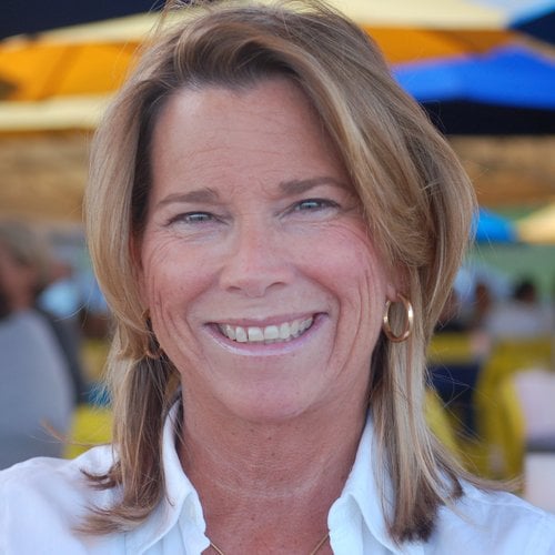 A headshot of a smiling woman