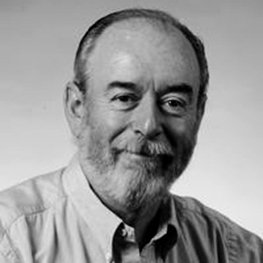 A headshot of a man in a button down shirt