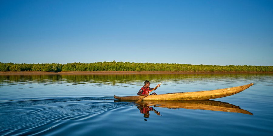 Lone fisher sets off in boat on coast of Madagascar