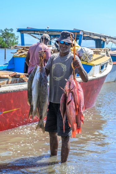 Man holds up his catch for the day