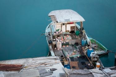 A fishing boat backed up to a dock