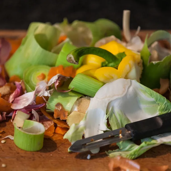 A color photo showing leftover food scraps on a table.