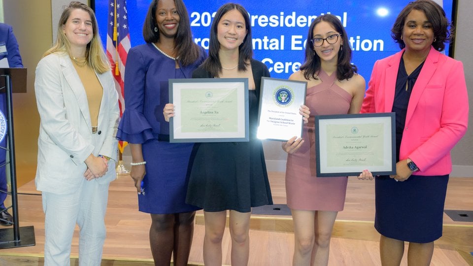 Five women holding award certificates