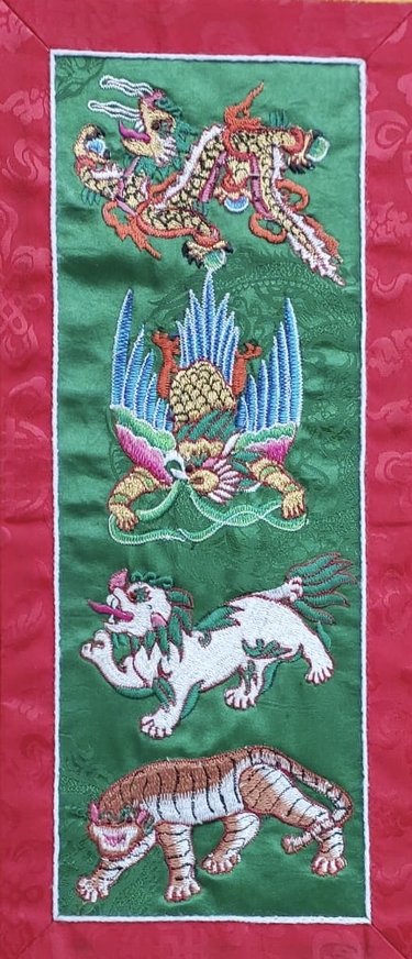 A sewn portrait of the four creatures honored in Bhutan