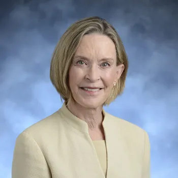 Smiling headshot of an older white woman with shoulder-length blond hair.