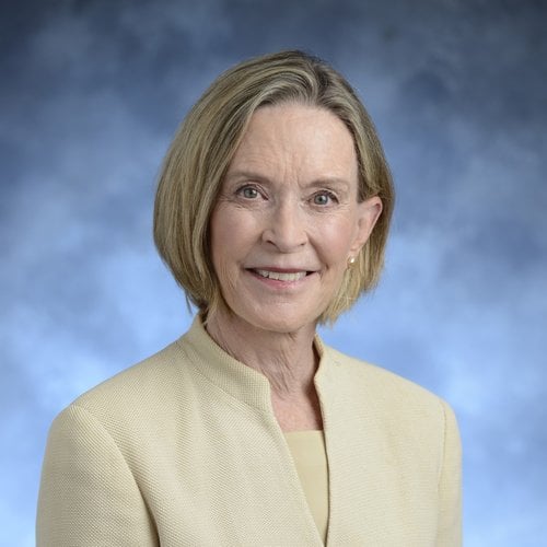 Smiling headshot of an older white woman with shoulder-length blond hair.