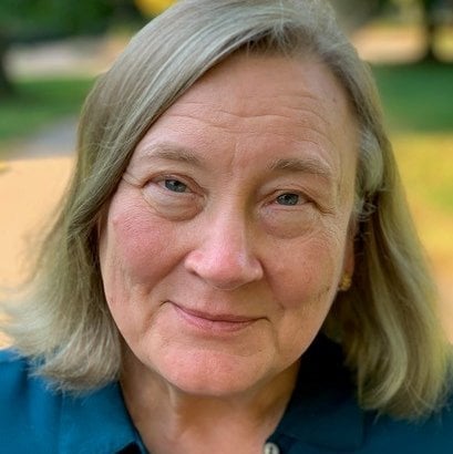 Headshot of Virginia smiling.