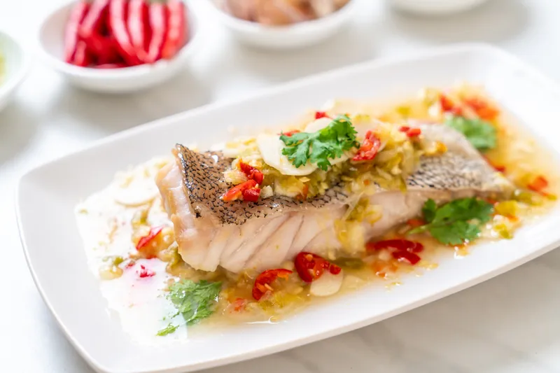 Steamed grouper fish filet with chili lime sauce in lime dressing