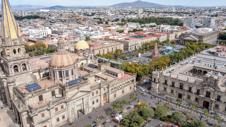 An aerial view of Guadalajara showcasing the city and a church in the foreground.