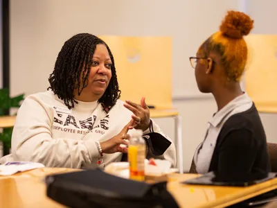 Renee Johnson, SVP of People and Culture, has a conversation with a student.