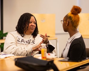 Renee Johnson, SVP of People and Culture, has a conversation with a student.