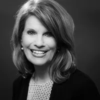 A headshot of Julie Miller smiling at the camera