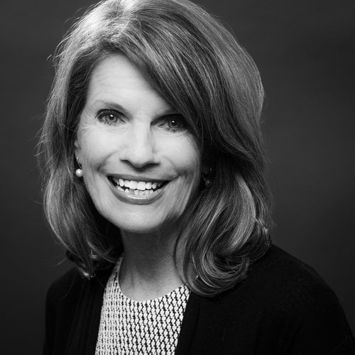 A headshot of Julie Miller smiling at the camera