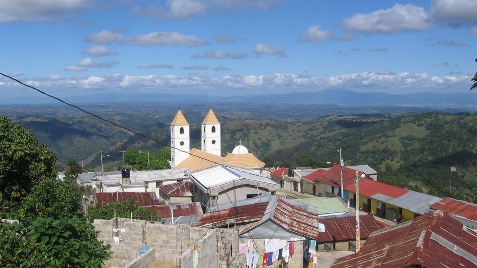 small town surrounded by green hills