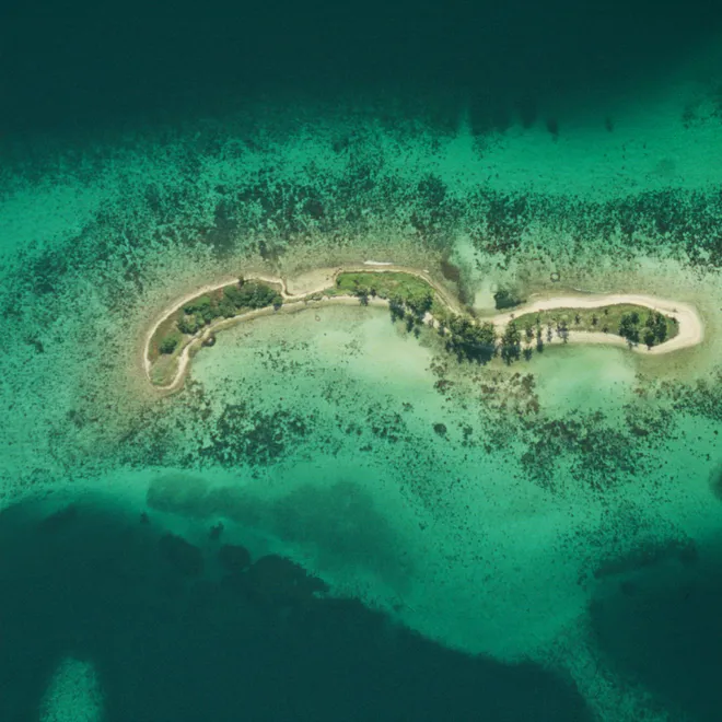 Aerial view of the coral reefs around Laughing Bird Caye National Park, Belize.