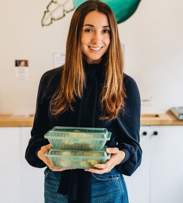 An image of Lauren Sweeney holding food containers