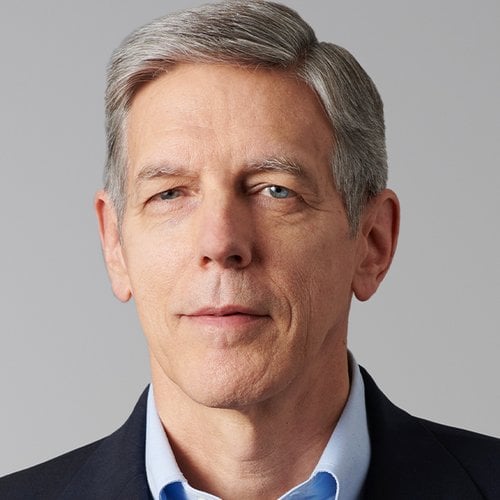 A head shot of a man with gray hair and a suit.