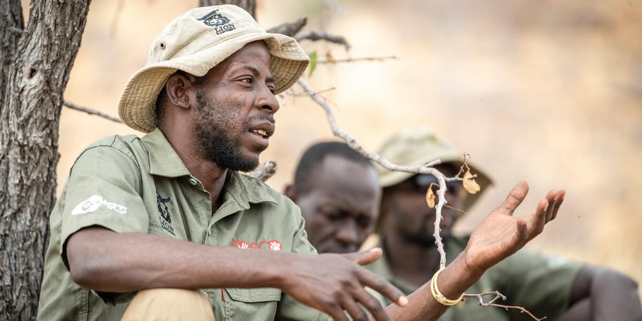 Lion Ranger Jendery Tsaneb sits under a tree and talks about human wildlife coexistence in Namibia