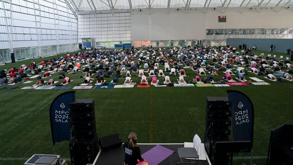 A large group of people participating in a yoga session