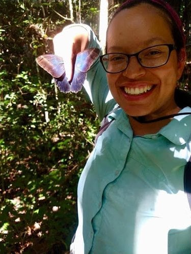 WWF scientist Mabel Baez Schon holds a buttefly specimen