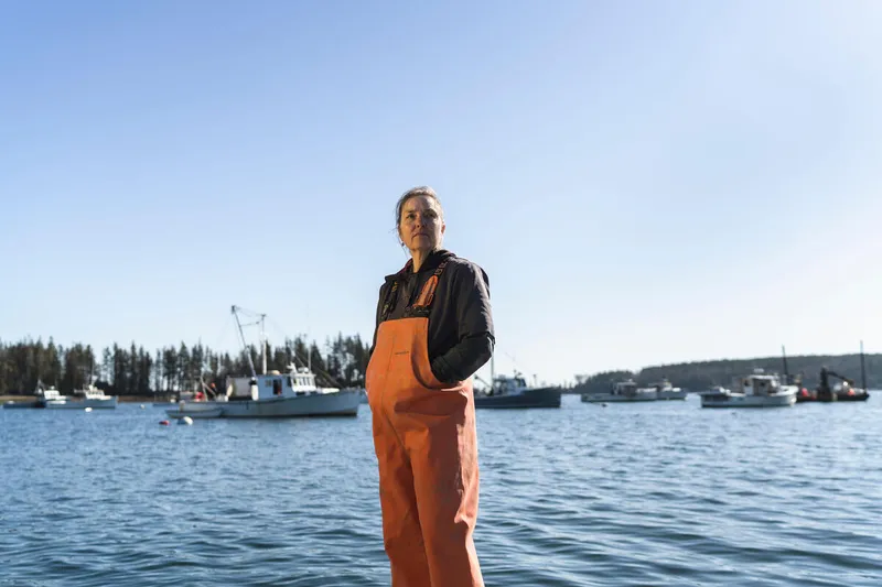 Seaweed farmer Karen Cooper stands on pier in Owls Head Harbor, Maine
