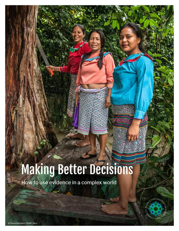 A report cover showing three women in brightly colored clothes smiling and standing near a tree with forest in the background