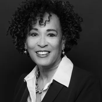 Black and white headshot of Marcene. She is a Black woman with ear-length curly hair.