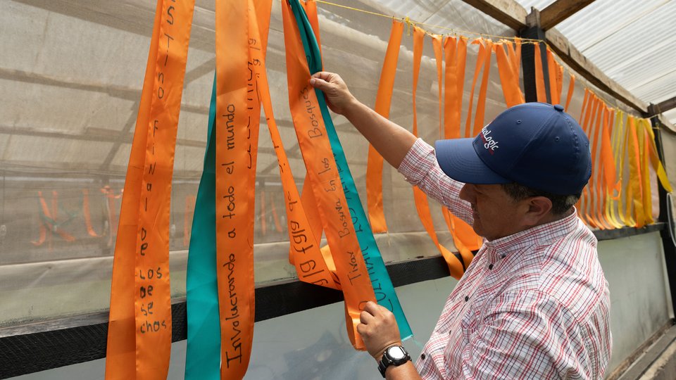 Mario Ardany De Leon, Program officer at EcoLogic Development Fund and EFN alumnus, shows ribbons with wishes from the children who have come to EcoLogic for environmental education programs.