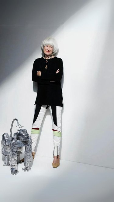 portrait of Mia Fonssagrives-Solow standing next to one of her robot sculptures a sculpture