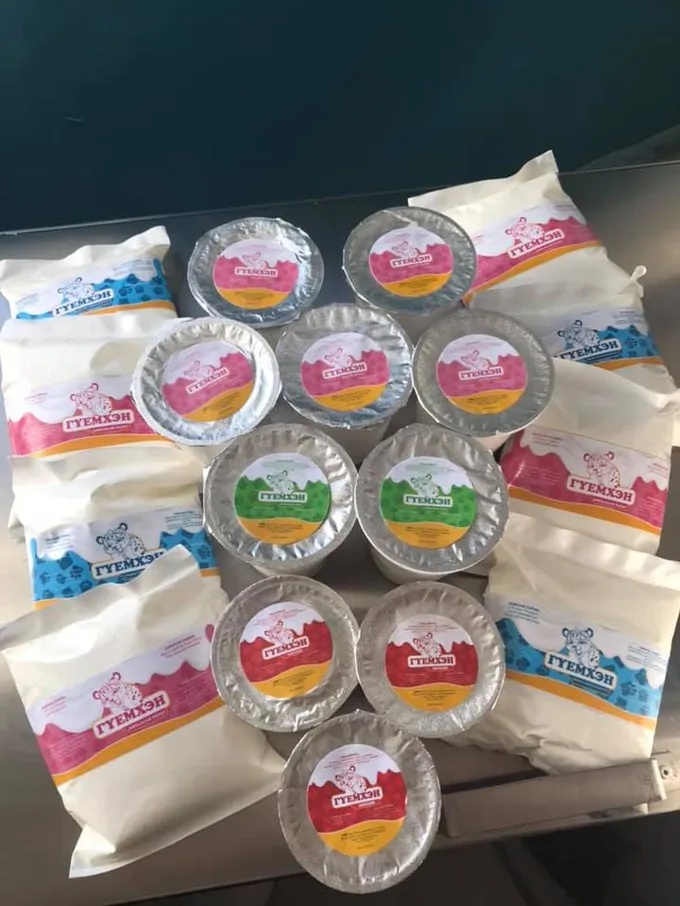 A pile of Mongolian yak dairy products in plastic pink and blue packaging