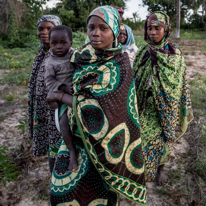 Women in indigenous clothing pose for camera