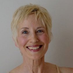 A close up headshot of the face of a woman with short hair