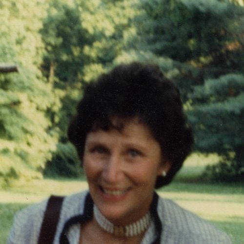 Photo of Marie Ridder taken outside with trees in the background