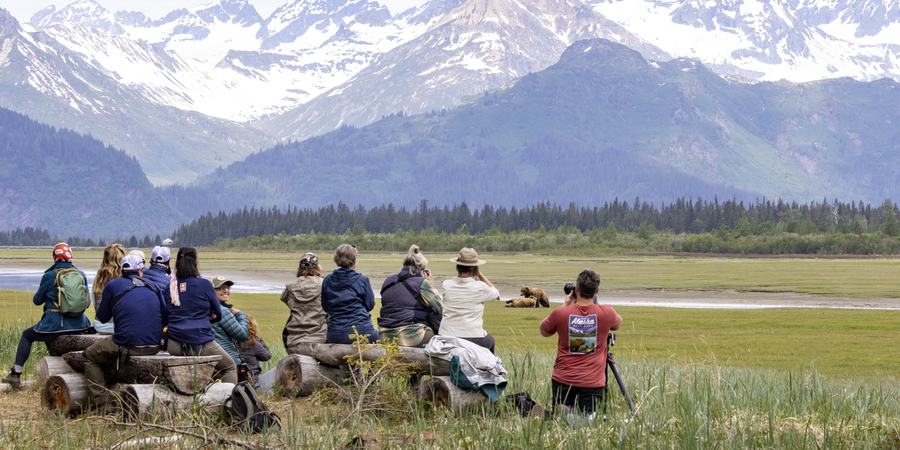 Travelers taking a photo in Alaska on Natural Habitat Adventures' Bear Camp trip