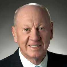 Headshot of Neville Isdell wearing a suit